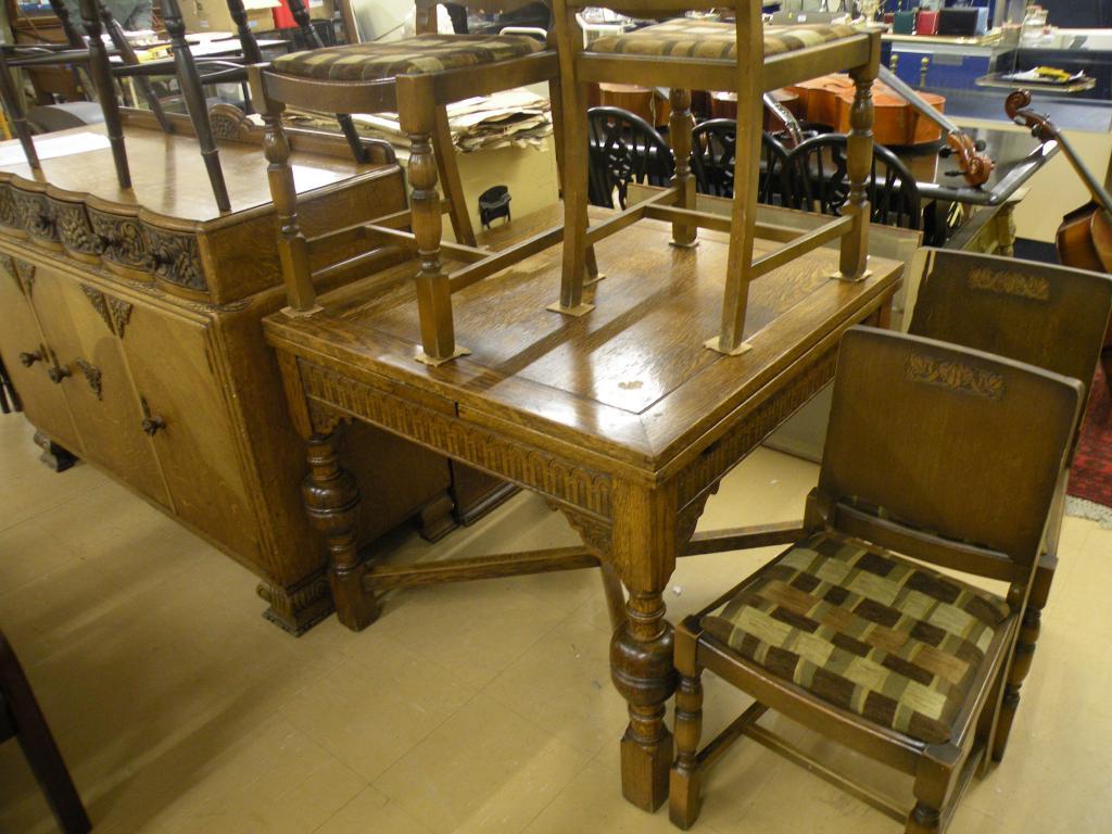 Appraisal: An oak draw leaf table an oak sideboard and four