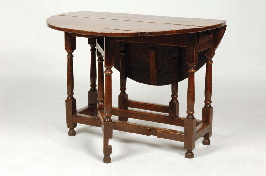 Appraisal: A CHARLES II OAK DROP FLAP DINING TABLE the oval