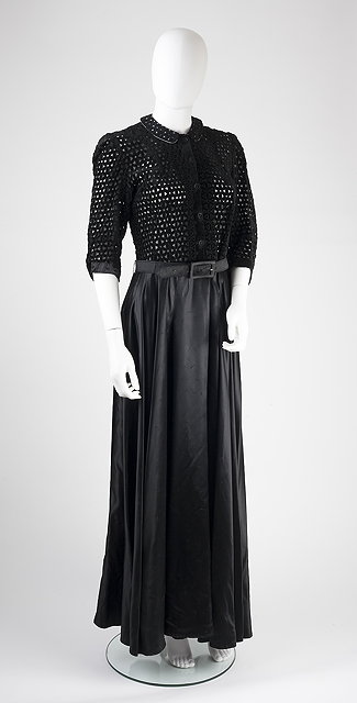 Appraisal: A black full length dress with velvet detailed bodice length