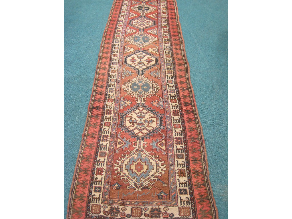 Appraisal: A bordered Hamadan Runner with geometric design on a red