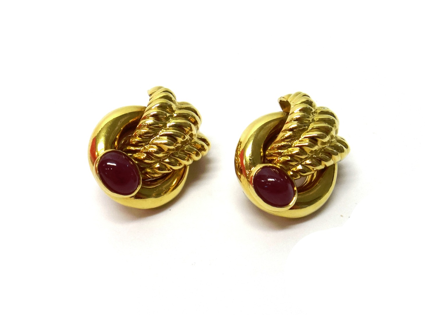 Appraisal: A pair of gold and cabochon ruby set earclips by