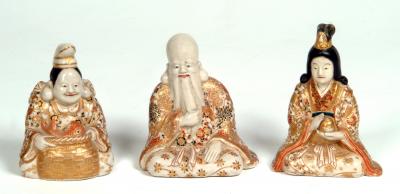 Appraisal: A SET OF THREE JAPANESE SATSUMA EARTHENWARE FIGURES modelled seated