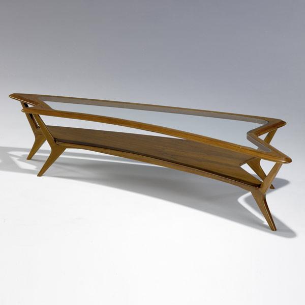 Appraisal: MODERN Sculpted walnut coffee table with inset glass to free-form