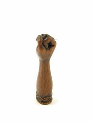 Appraisal: An early th century carved oak pipe tamper modelled as