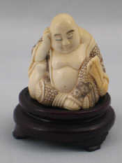 Appraisal: A Chinese ivory figure of a meditating Buddha signed on