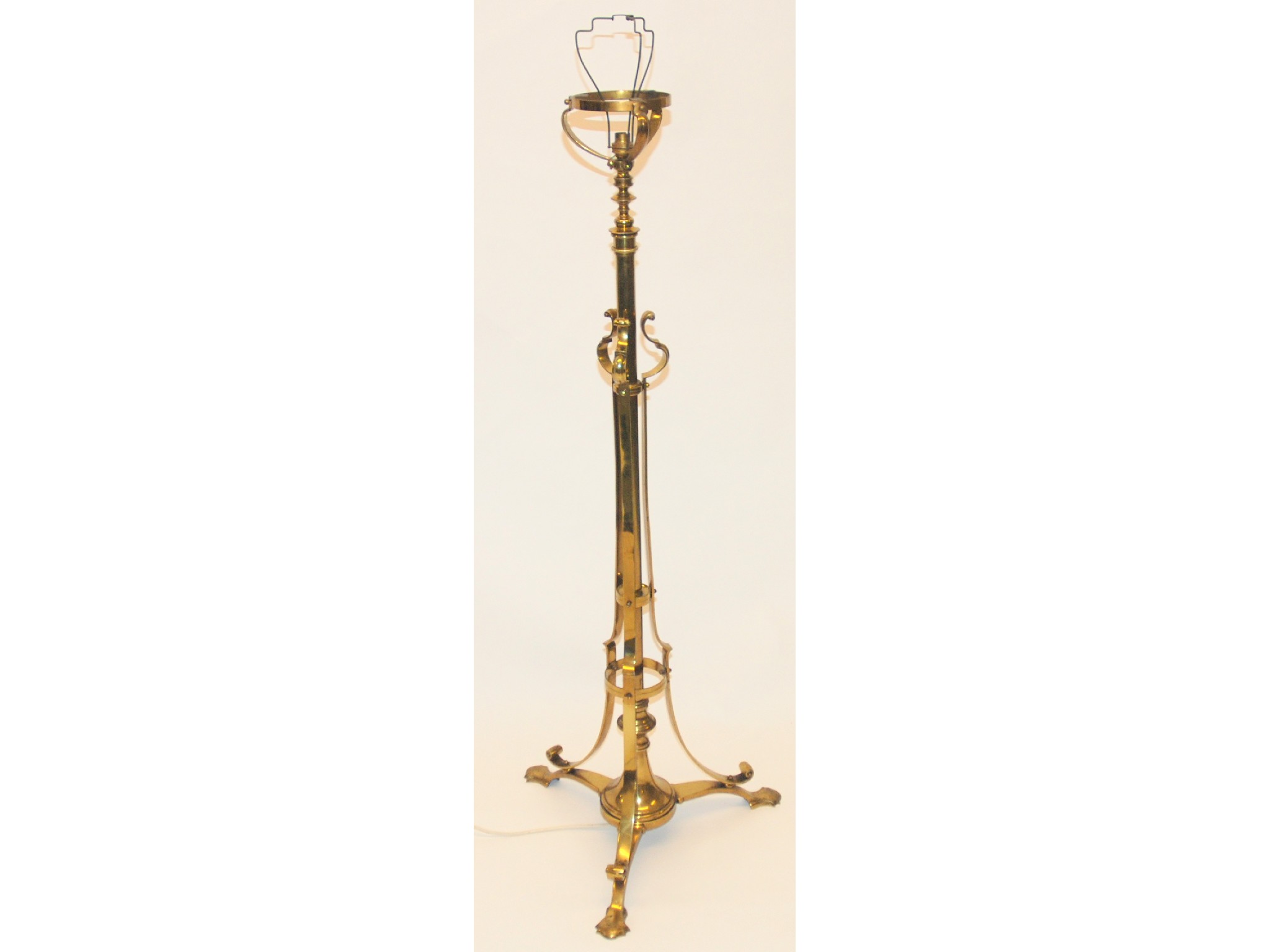 Appraisal: An Arts and Crafts brass standard lampthe adjustable column with