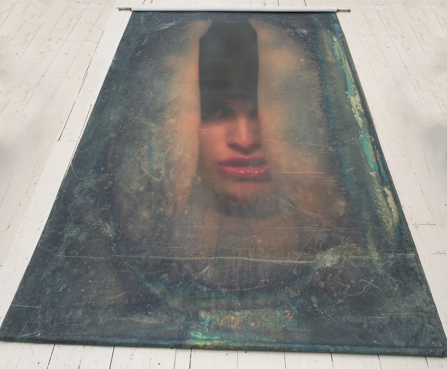 Appraisal: A PHOTOGRAPHIC SCROLL WITH BRONZE FINIALS DEPICTING A WOMAN'S FACE