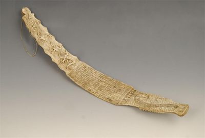 Appraisal: A carved and scrimshaw whalebone with serpent and a lizard