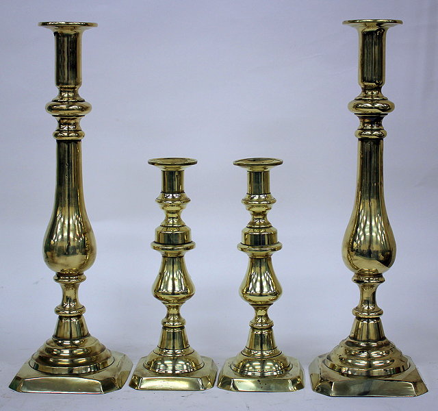 Appraisal: A PAIR OF LARGE BRASS CANDLESTICKS with baluster stems and