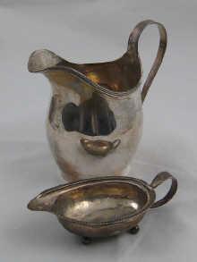 Appraisal: A silver milk jug with reeded rim and handle by