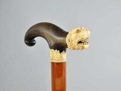 Appraisal: A Walking Cane with Decorative Handle A wood cane with