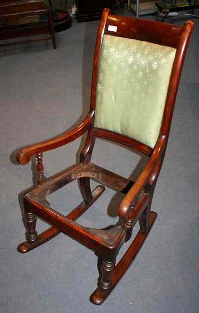 Appraisal: A VICTORIAN MAHOGANY ROCKING CHAIR with baluster turned supports seat