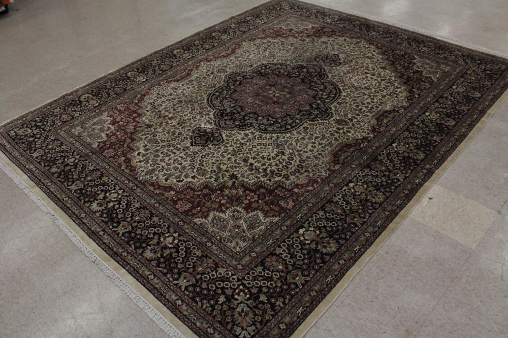 Appraisal: HAND KNOTTED ORIENTAL CARPET Indo-Persian floral and central floral medallion