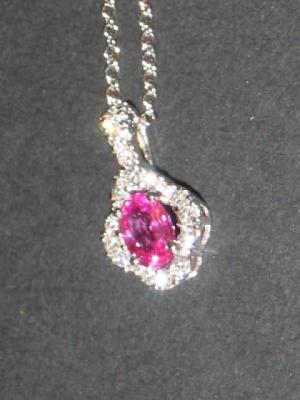 Appraisal: A PINK SAPPHIRE AND DIAMOND PENDANT the oval cut sapphire