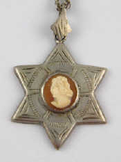 Appraisal: A white metal tests silver star of David pendant set