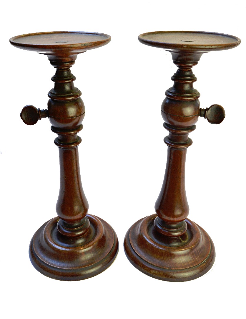 Appraisal: A pair of Victorian turned mahogany candlesticks mid th century