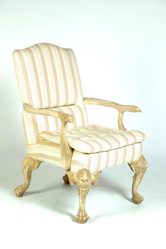 Appraisal: GEORGE III-STYLE ARMCHAIR Twentieth century Elaborately carved with lion and