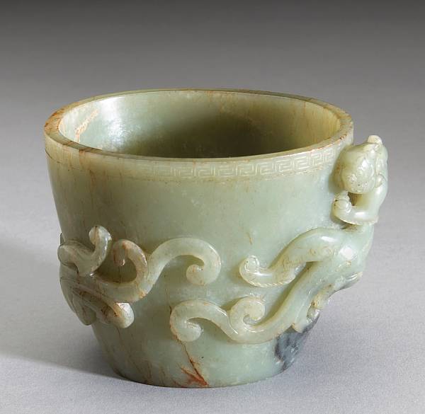 Appraisal: A celadon jade libation cup Of oval section with in-curving