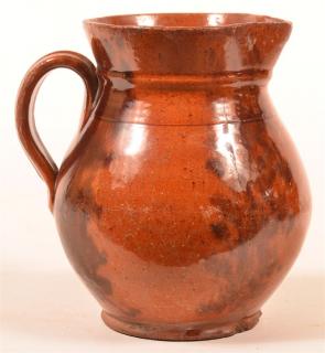 Appraisal: th Century Redware Mottle Glazed Pottery Pitcher Applied loop handle