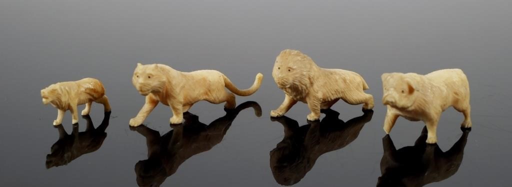 Appraisal: Miniature carved ivory bulldog and three lions Longest cat measures