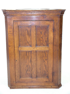 Appraisal: An oak corner cabinet th century the moulded cornice above