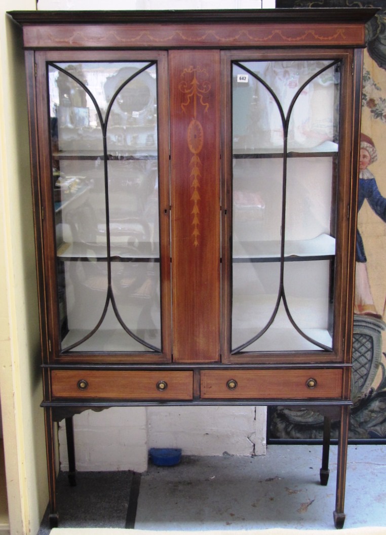 Appraisal: An Edwardian marquetry inlaid mahogany display cabinet with a pair