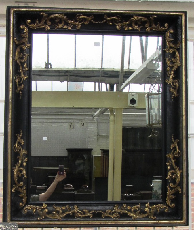 Appraisal: A th century and later parcel gilt ebonised wall mirror