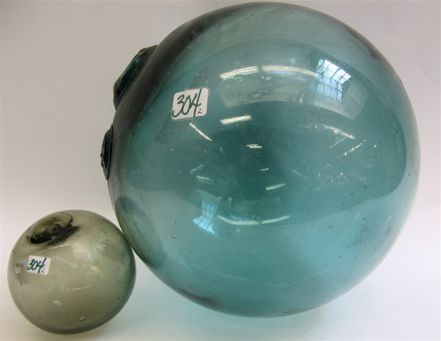 Appraisal: TWO JAPANESE COLORED GLASS FISHING FLOATS the larger in green