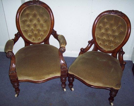 Appraisal: A pair of Victorian walnut framed button back open armchairs