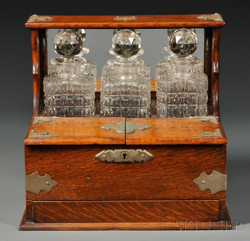 Appraisal: Victorian Oak Three-bottle Tantalus England late th century back portion