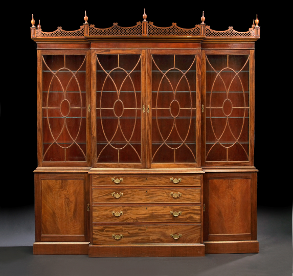 Appraisal: Georgian-Style Mahogany Breakfront Bookcase the shaped and pierced pediment with