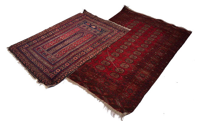 Appraisal: AN AFGHAN WINE GROUND RUG with three rows of medallions