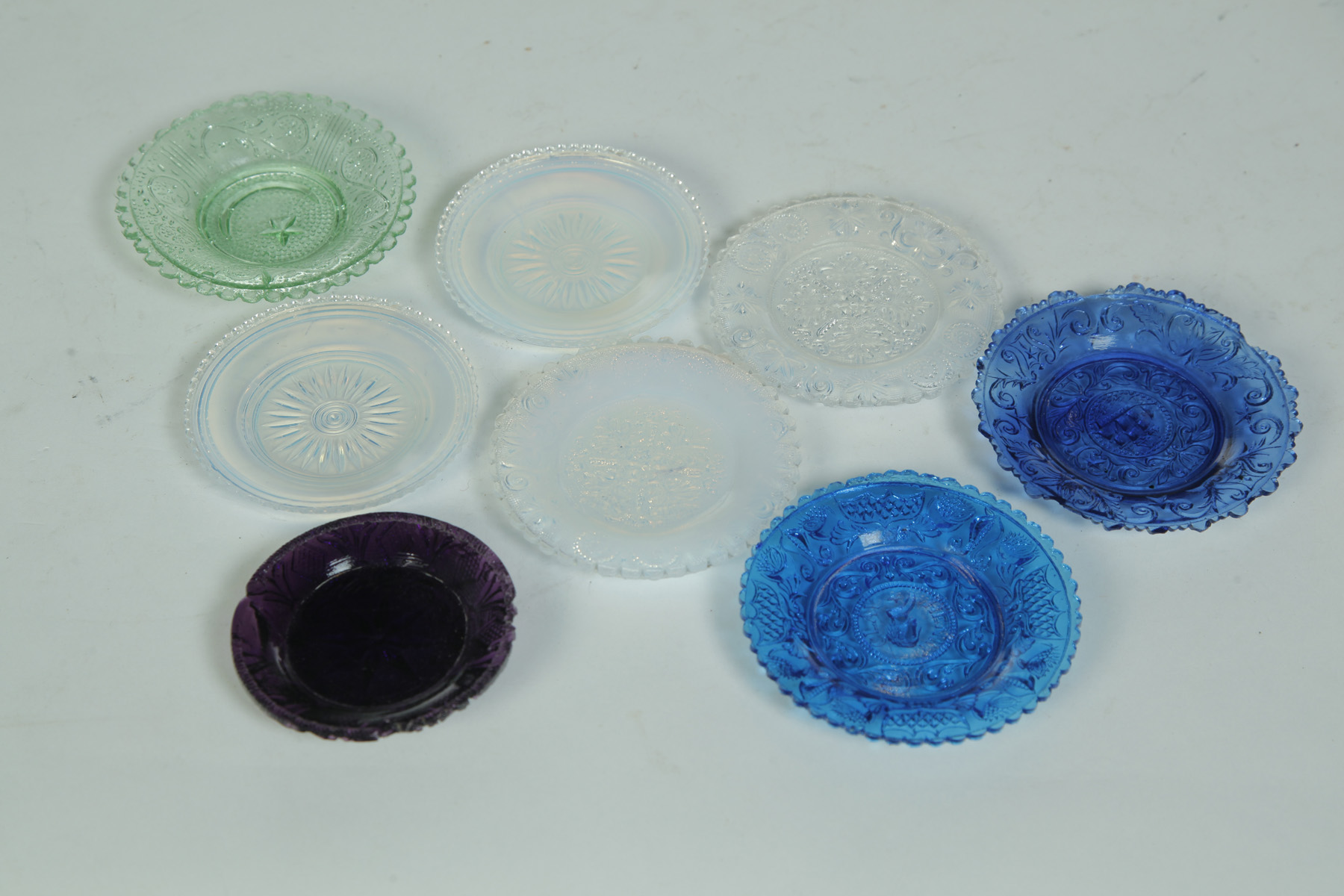 Appraisal: EIGHT VARIOUS LACY GLASS CUP PLATES - FOUR IN COLOR