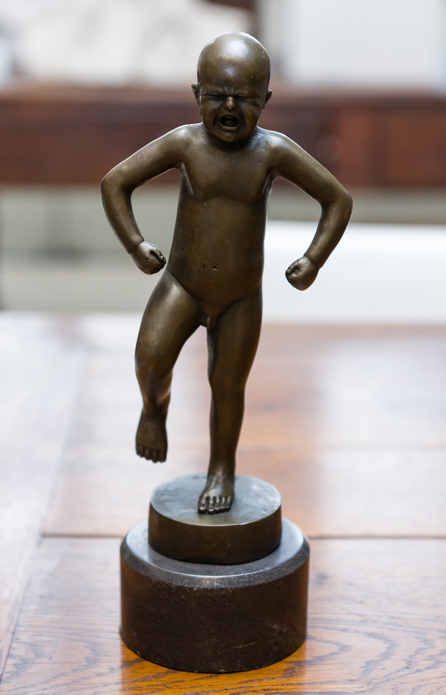 Appraisal: A BRONZE OF AN ANGRY TODDLER ON A MARBLE BASE