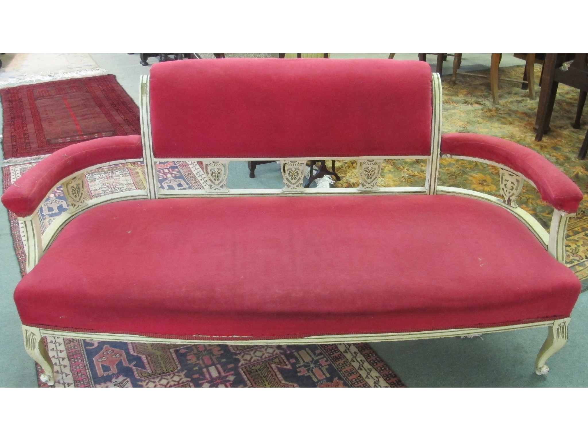 Appraisal: A Victorian settee with pink upholstery and painted wooden frame