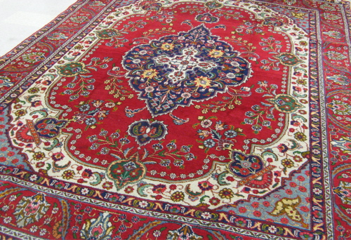 Appraisal: HAND KNOTTED PERSIAN TABRIZ CARPET floral and central floral medallion