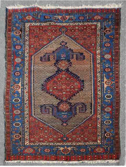 Appraisal: AN ANTIQUE PERSIAN HAMADAN RUG decorated with central diamond medallion