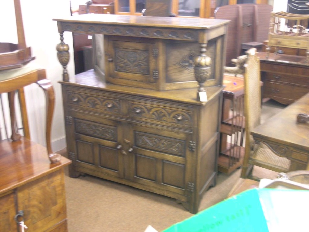 Appraisal: A reproduction solid dark oak court cupboard carved lunette frieze