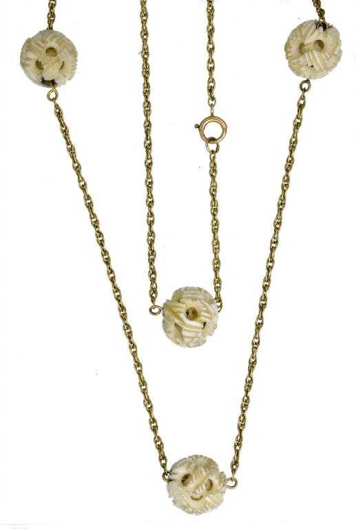 Appraisal: A GOLD AND IVORY NECKLET with six Chinese ivory 'puzzle