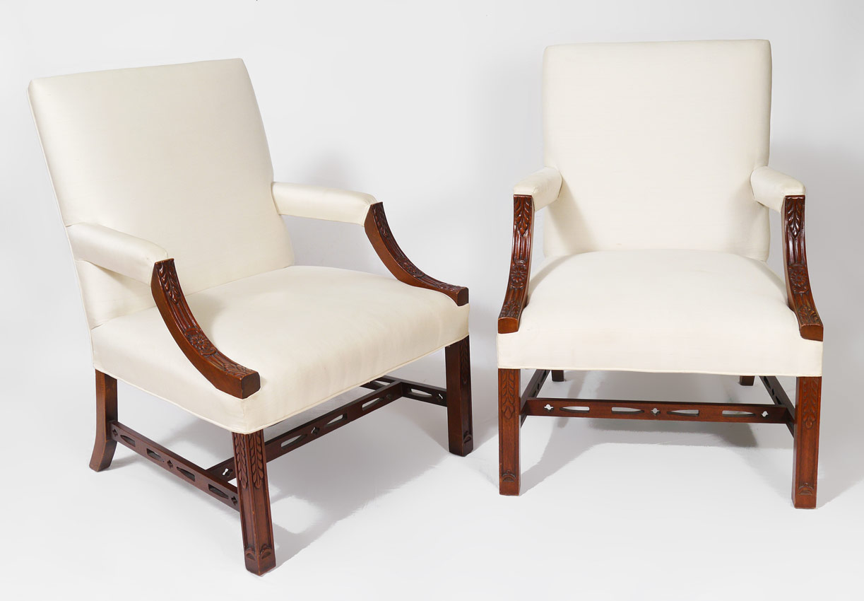 Appraisal: PAIR RAEBURN CARVED LOLLING CHAIRS White upholstered back armrests and