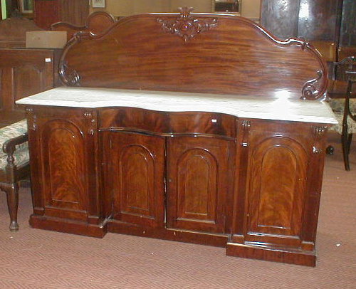 Appraisal: A Victorian flamed mahogany serpentine sideboard with carved and raised