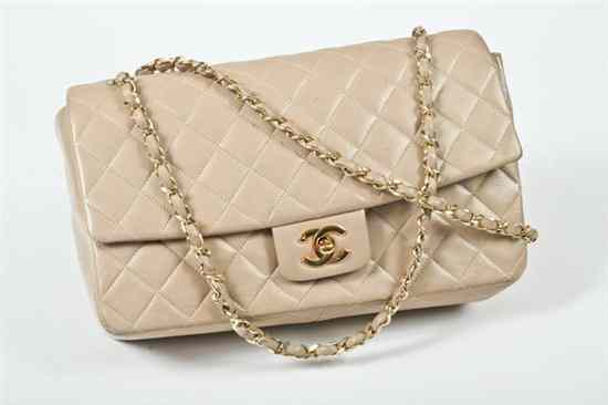 Appraisal: CHANEL BEIGE LEATHER HANDBAG Matching interior fitted with zipper and