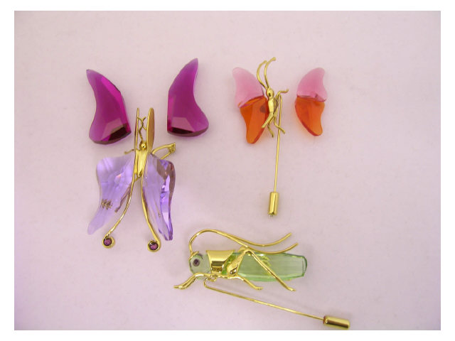 Appraisal: Three Swarovski stick pins two depicting butterflies crystals need reattached