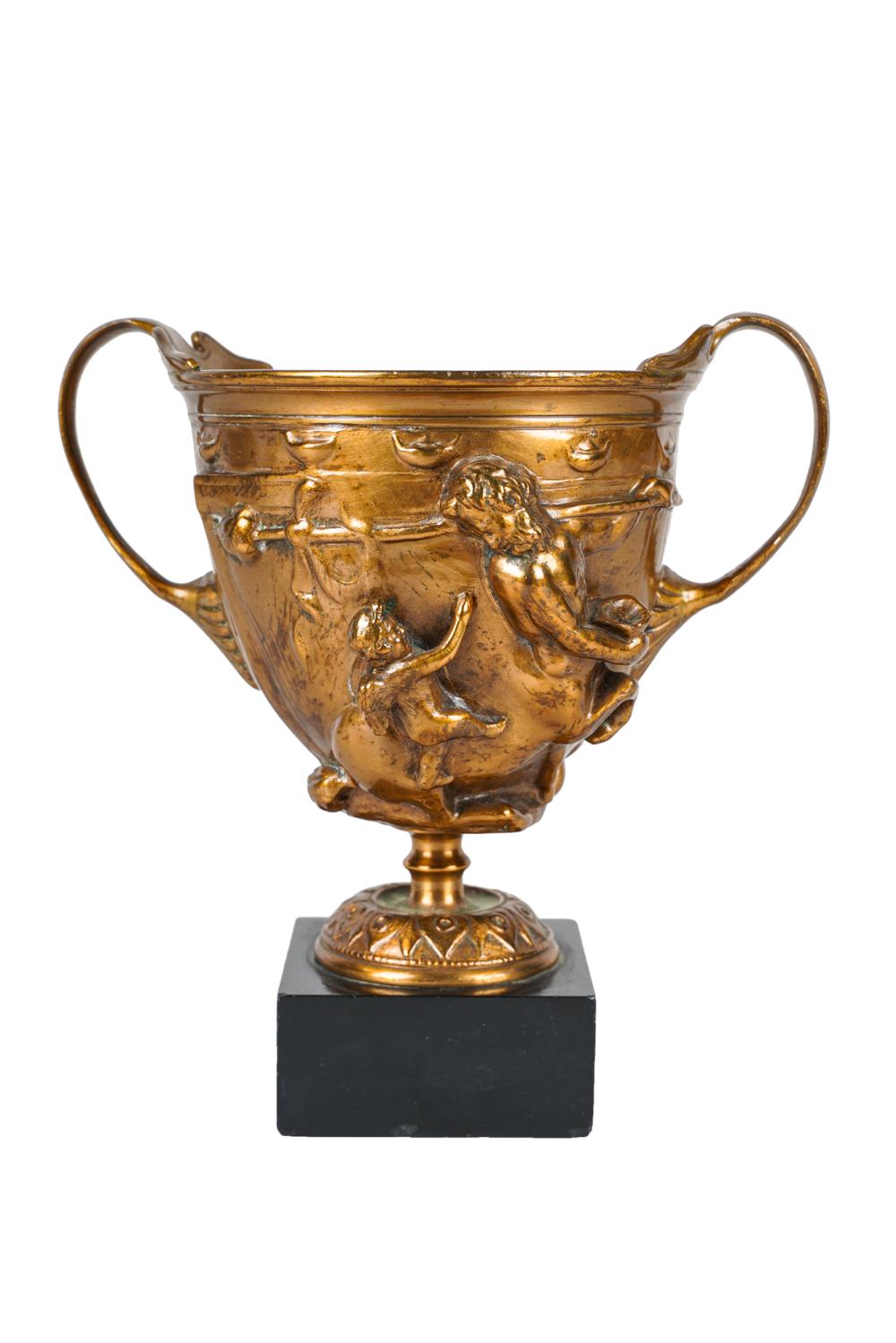 Appraisal: GILT-BRONZE CHALICEdecorated with centaurs and putti mounted to a black