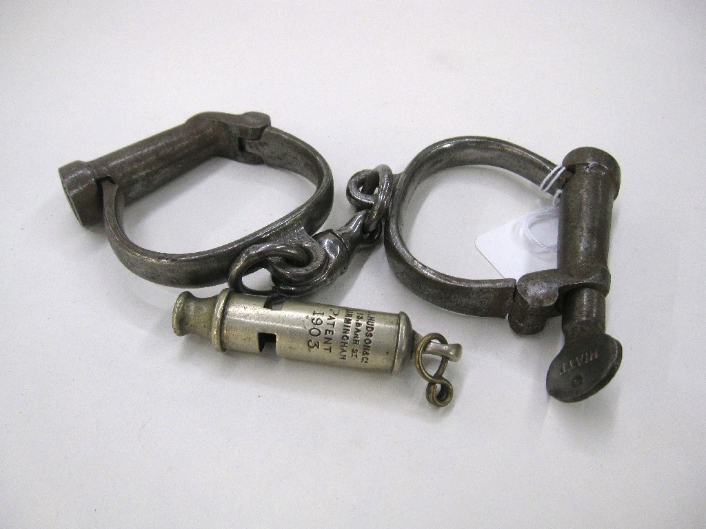 Appraisal: Lot comprising pair of Hiatt handcuffs and a whistle