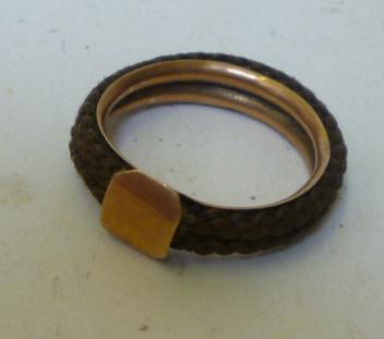 Appraisal: A HAIRWORK RING having two plaited hair work bands mounted