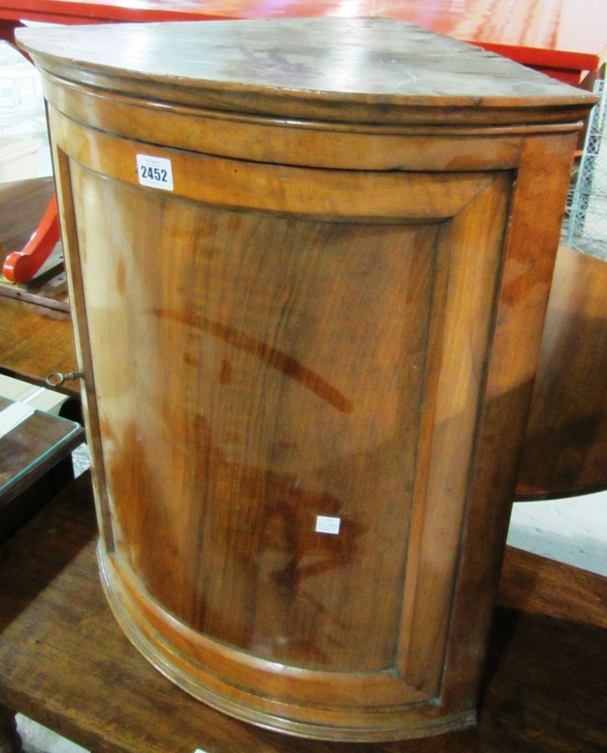 Appraisal: A th century walnut small hanging corner cupboard