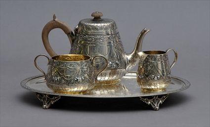 Appraisal: VICTORIAN ARMORIAL THREE-PIECE INDIVIDUAL TEA SET AND AN AMERICAN SILVER