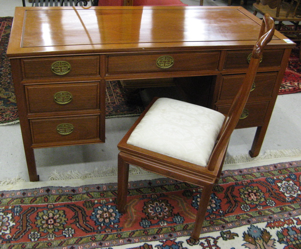 Appraisal: A TEAKWOOD WRITING DESK AND CHAIR Chinese th century The