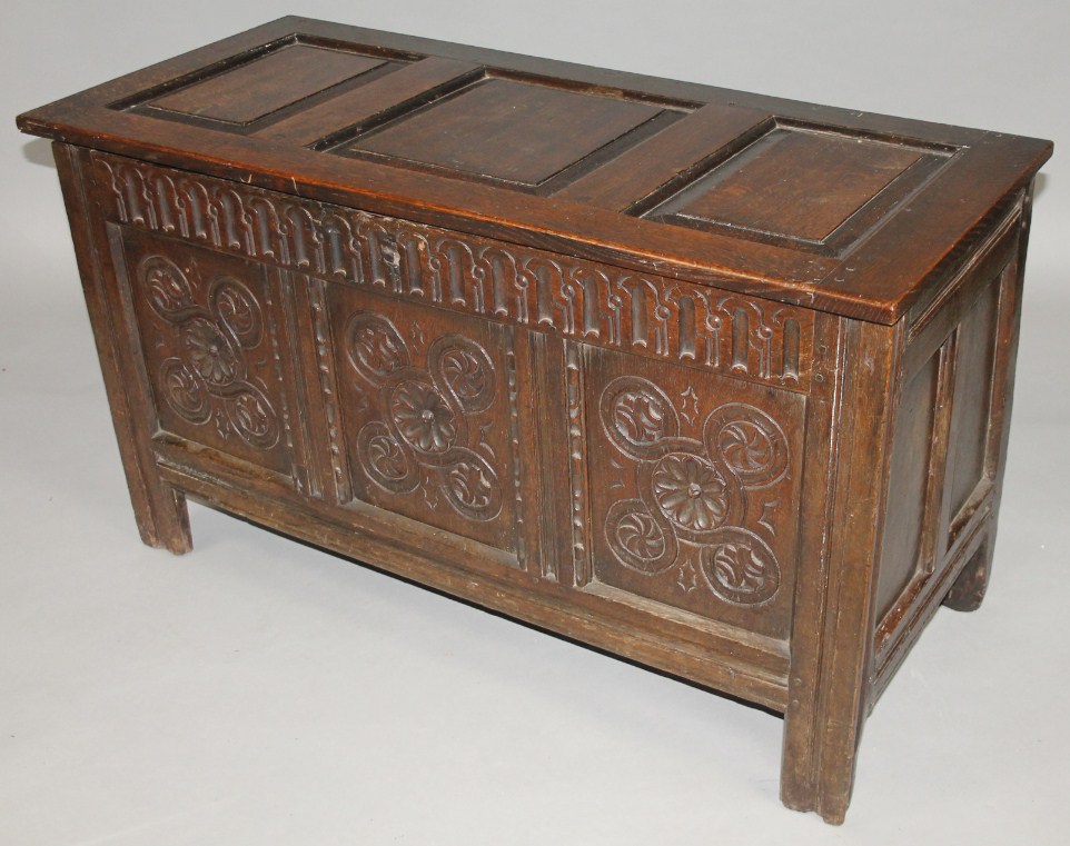 Appraisal: An thC panelled oak coffer the front carved with roundels